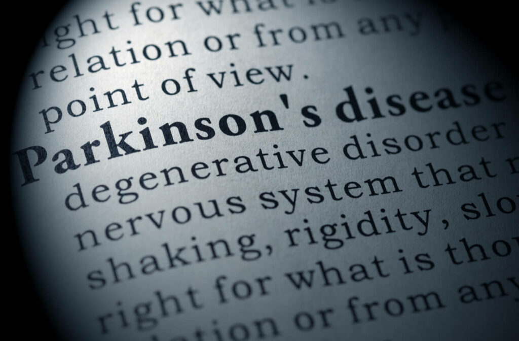 a close up shot of a book with the dictionary definition with words cut off: Parkinson's disease: degenerative disorder nervous system that shaking, rigitidity, right for what is tho...