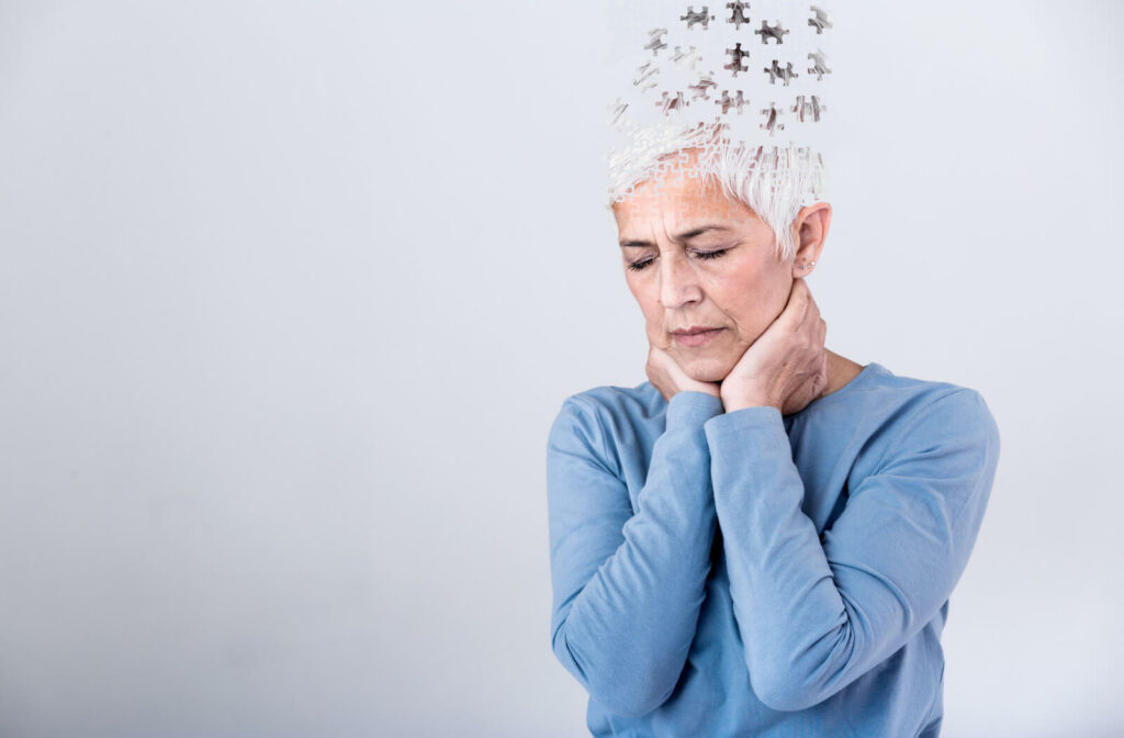 A senior woman loses parts of head as a symbol of decreased mind function.
